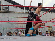 building crowd fight pose:kneeling pose:one_arm_up pose:pointing pose:standing shirtless short_hair sport squared_circle subject:human type:photograph wrestler wrestling // 2667x2000 // 667KB