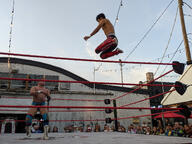 building crowd fight pose:jumping pose:standing shirtless short_hair sport squared_circle subject:human type:photograph wrestler wrestling // 2667x2000 // 582KB
